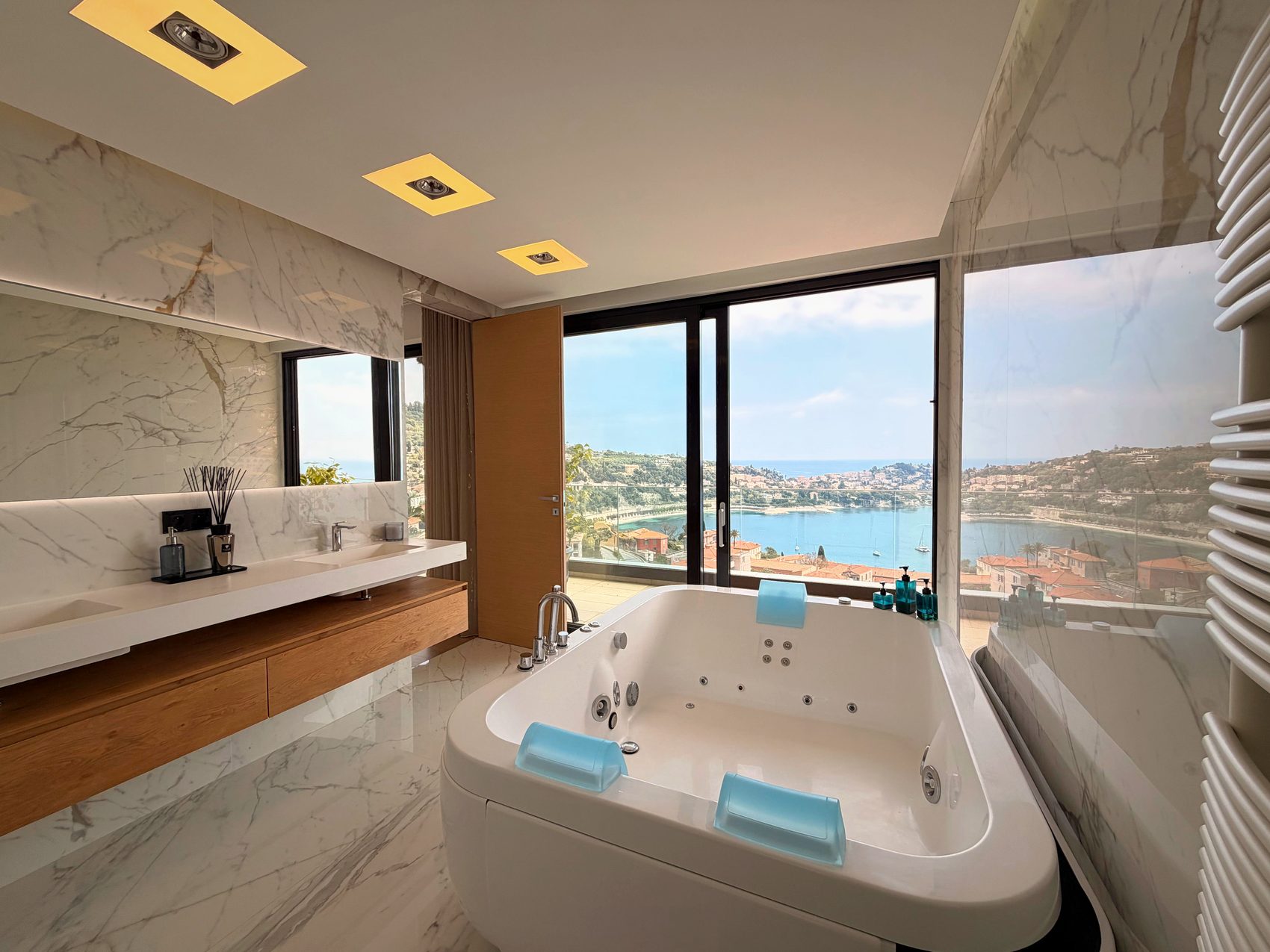Salle de bains privative avec baignoire devant une fenêtre sur la baie